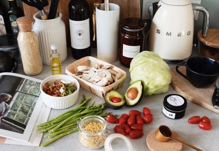 A variety of fresh ingredients and kitchen tools for preparing a healthy meal.
