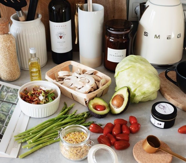 A variety of fresh ingredients and kitchen tools for preparing a healthy meal.